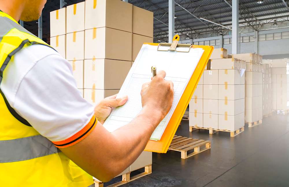 Veristic inspector recording stock in a warehouse